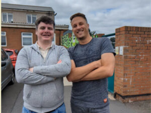 Daryll and Jonny standing in the Edinburgh Dog and Cat Home car park with their arms folded