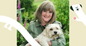 Doreen Graham and Charlie the dog with Edinburgh Dog and Cat Home graphics across the screen